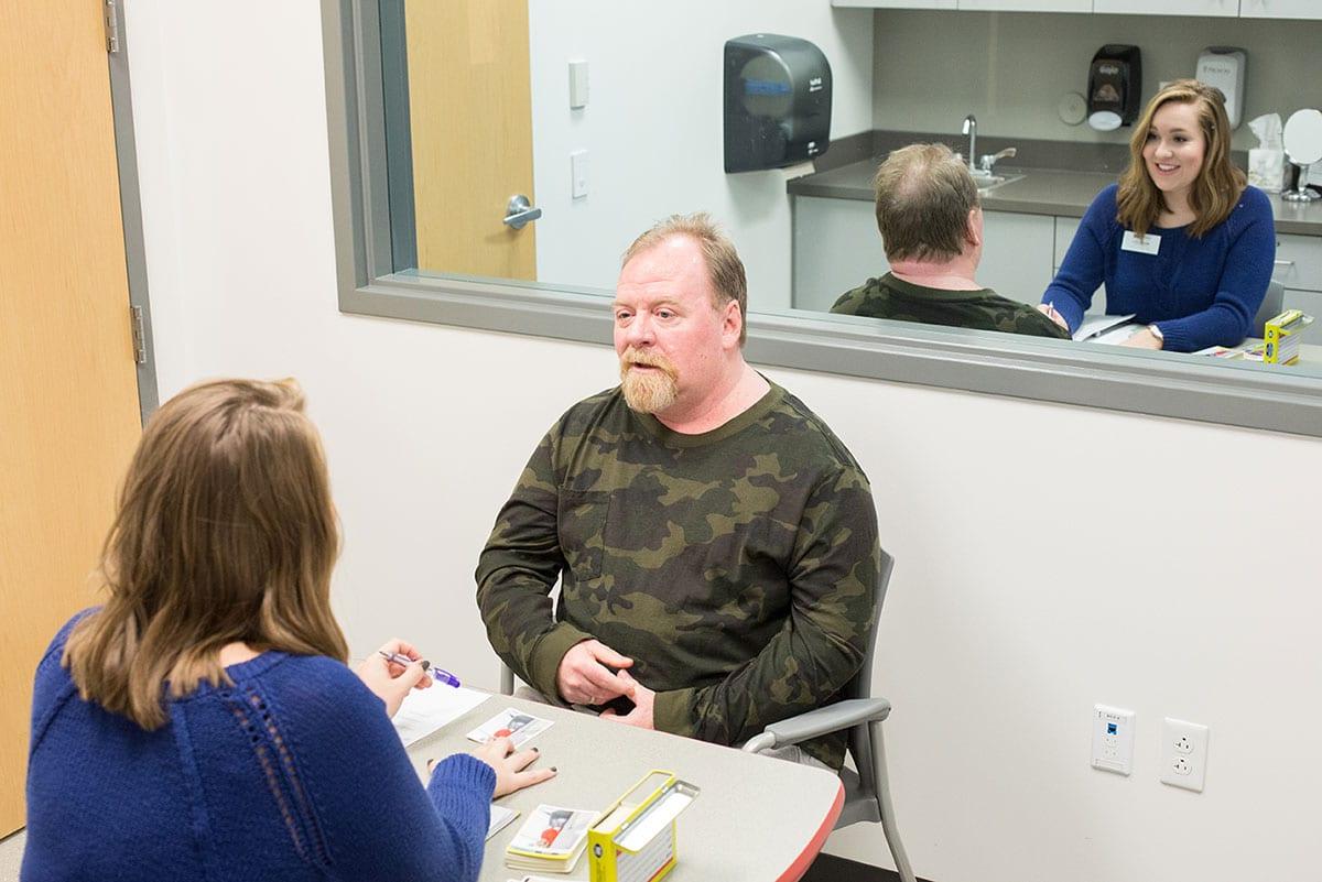 speech language pathology student assisting a patient